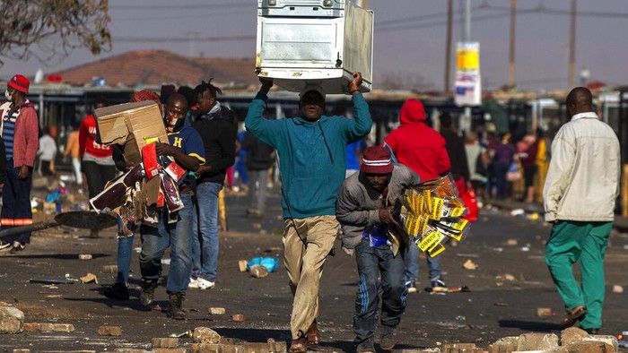 A soldier patrols inside a trashed shopping mall in Soweto, near Johannesburg, Tuesday July 13, 2021. South Africas rioting continued Tuesday as police and the military tried to halt the unrest in poor areas of two provinces, in Gauteng and KwaZulu-Natal, that began last week after the imprisonment of former President Jacob Zuma. (AP Photo/Themba Hadebe)