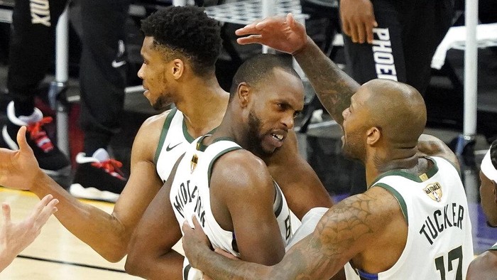 Milwaukee Bucks Giannis Antetokounmpo, from left, celebrates with Khris Middleton and P.J. Tucker during the second half of Game 5 of basketballs NBA Finals against the Phoenix Suns, Saturday, July 17, 2021, in Phoenix. (AP Photo/Matt York)