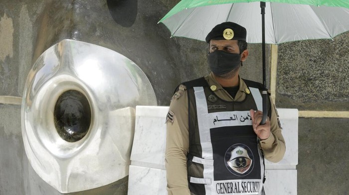 Hajar Aswad A Saudi policeman stands alert beside Al-Hajar al-Aswad, the black stone, at right, a Muslim holy relic which according to Islamic tradition dates back to the time of Adam and Eve, at the Grand Mosque, a day before the annual hajj pilgrimage, Saturday, July 17, 2021. The pilgrimage to Mecca required once in a lifetime of every Muslim who can afford it and is physically able to make it, used to draw more than 2 million people. But for a second straight year it has been curtailed due to the coronavirus with only vaccinated people in Saudi Arabia able to participate. (AP Photo/Amr Nabil)