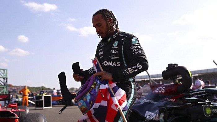 Mercedes driver Lewis Hamilton of Britain gets out of his car after winning the British Formula One Grand Prix, at the Silverstone circuit, in Silverstone, England, Sunday, July 18, 2021. (Lars Baron/Pool photo via AP)