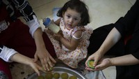 Beragam kue tersebut dibuat bersama anggota keluarga lainnya beberapa hari sebelum Hari Raya Idul Adha. AP Photo/Majdi Mohammed.