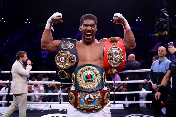DIRIYAH, SAUDI ARABIA - DECEMBER 07: Anthony Joshua poses for a photo with the IBF, WBA, WBO & IBO World Heavyweight Title belts after the IBF, WBA, WBO & IBO World Heavyweight Title Fight between Andy Ruiz Jr and Anthony Joshua during the Matchroom Boxing Clash on the Dunes show at the Diriyah Season on December 07, 2019 in Diriyah, Saudi Arabia (Photo by Richard Heathcote/Getty Images)