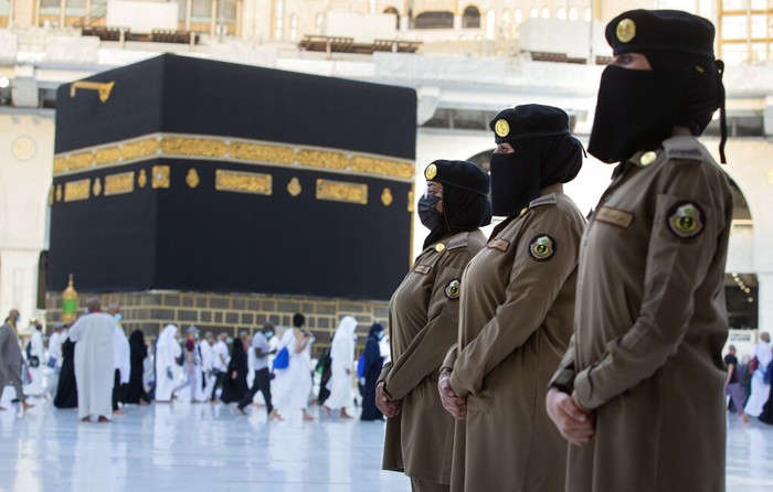 Saudi police woman, Bashair, left, adjusts the veil of her colleague Alaa, as they recently deployed to the service at the Grand Mosque, during the annual hajj pilgrimage, in the Saudi Arabias holy city of Mecca, Tuesday, July 20, 2021. (AP Photo/Amr Nabil)