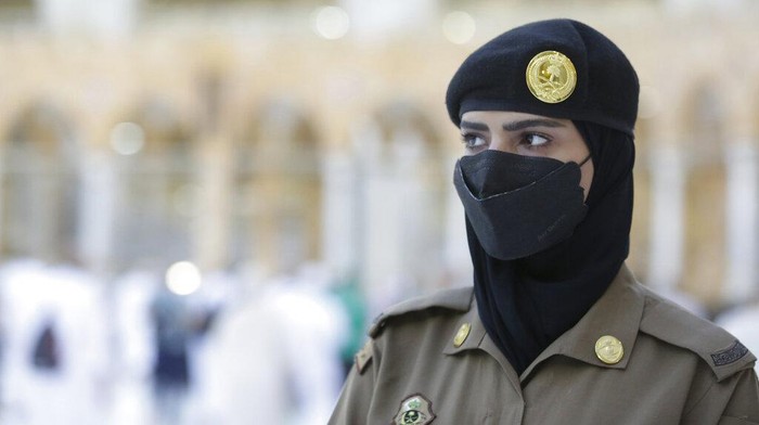 Saudi police woman, Bashair, left, adjusts the veil of her colleague Alaa, as they recently deployed to the service at the Grand Mosque, during the annual hajj pilgrimage, in the Saudi Arabias holy city of Mecca, Tuesday, July 20, 2021. (AP Photo/Amr Nabil)