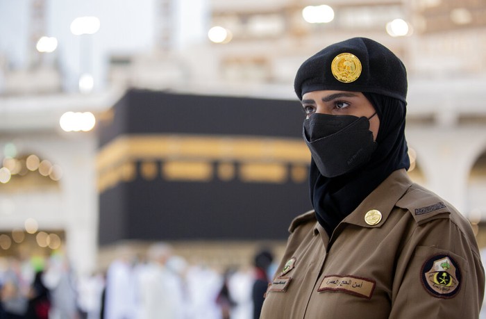 Saudi police woman, Bashair, left, adjusts the veil of her colleague Alaa, as they recently deployed to the service at the Grand Mosque, during the annual hajj pilgrimage, in the Saudi Arabias holy city of Mecca, Tuesday, July 20, 2021. (AP Photo/Amr Nabil)
