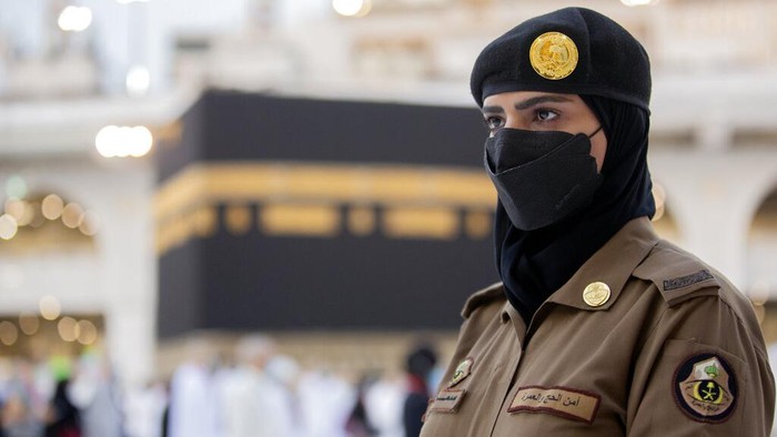 Saudi police woman, Bashair, left, adjusts the veil of her colleague Alaa, as they recently deployed to the service at the Grand Mosque, during the annual hajj pilgrimage, in the Saudi Arabias holy city of Mecca, Tuesday, July 20, 2021. (AP Photo/Amr Nabil)