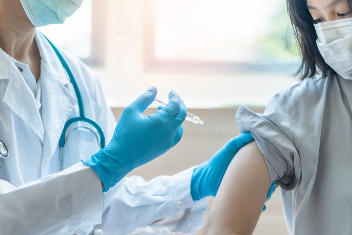 vaksin Immunization and vaccination for flu shot, influenza, HPV or Covid-19 prevention with young child girl having vaccine injection for World immunization week and International HPV awareness day