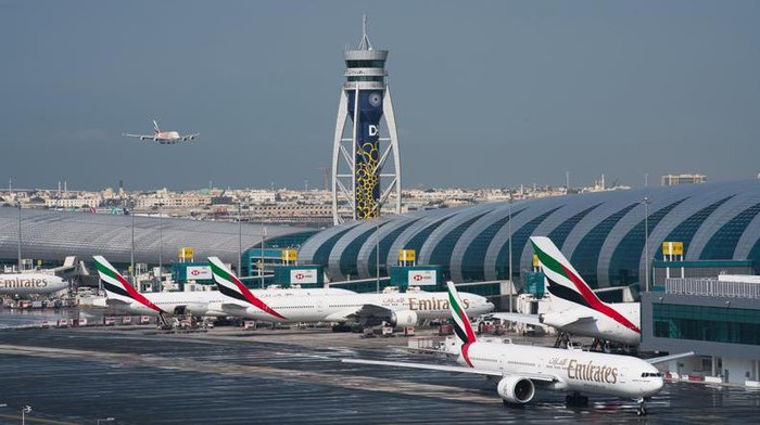 FILE - In this Dec. 11, 2019, file photo, an Emirates jetliner comes in for landing at the Dubai International Airport in Dubai, United Arab Emirates. Two passenger jets from low-cost carrier FlyDubai and Bahrain-based Gulf Air collided with each other on the taxiway at Dubai International Airport early Thursday, July 22, 2021, though authorities reported no injuries in the incident. (AP Photo/Jon Gambrell, File)