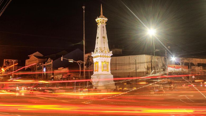 Tugu Jogja with slow shutter long exposure at night and fire light trail effect. This picture taken in Yogyakarya Indonesia. Tugu Jogja is a icon of Yogyakarya City.