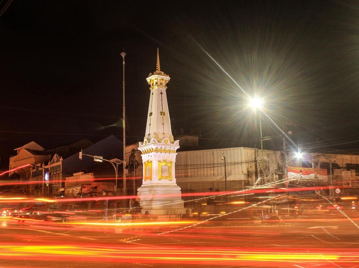 Tugu Jogja with slow shutter long exposure at night and fire light trail effect. This picture taken in Yogyakarya Indonesia. Tugu Jogja is a icon of Yogyakarya City.