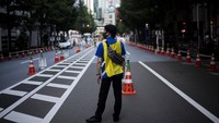 Petugas menunggu tibanya bus yang akan membawa peserta Olimpiade Tokyo 2020 di Shinjuku, Tokyo, Jepang, Rabu (21/7/2021).