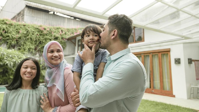 Happy family celebrating during party. They are enjoying at back yard.