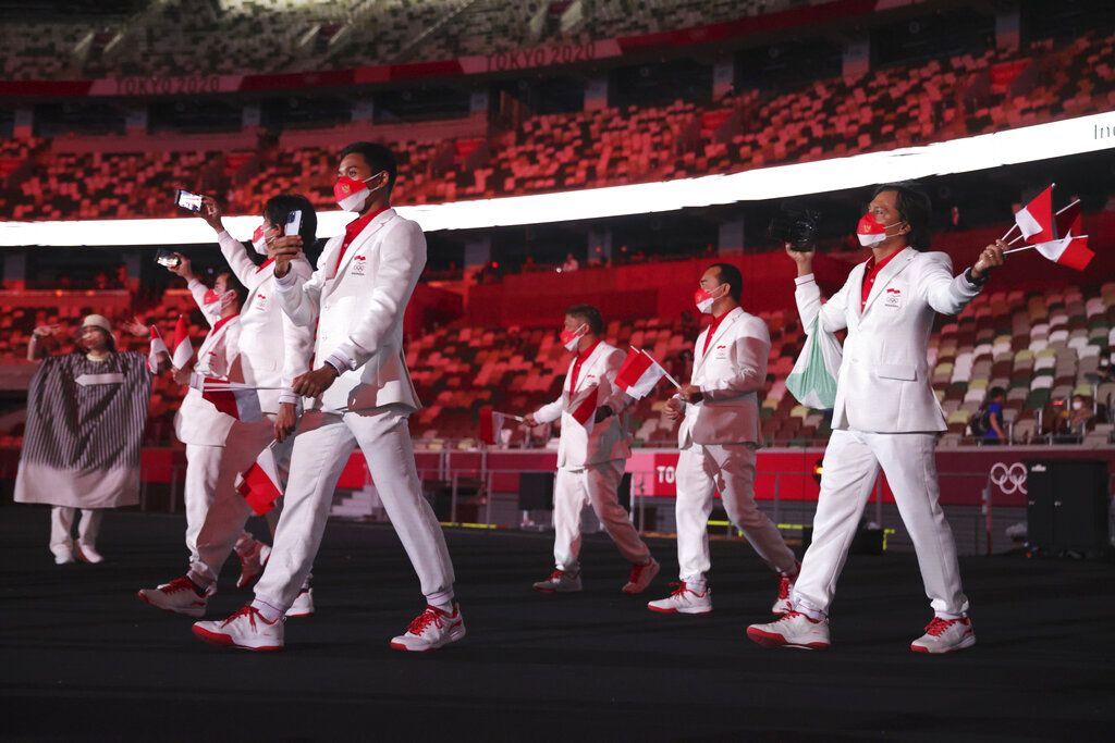 Team Indonesia during the opening ceremony in the Olympic Stadium at the 2020 Summer Olympics, Friday, July 23, 2021, in Tokyo, Japan. (Hannah McKay/Pool Photo via AP)