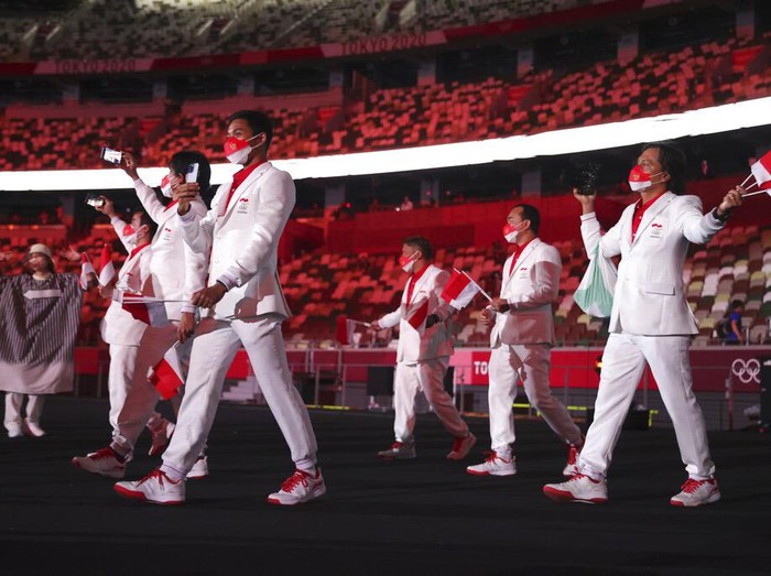 Team Indonesia during the opening ceremony in the Olympic Stadium at the 2020 Summer Olympics, Friday, July 23, 2021, in Tokyo, Japan. (Hannah McKay/Pool Photo via AP)