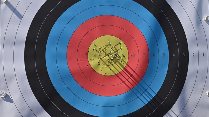 This picture shows arrows on a target shot by South Koreas Kim Je-doek in the mens individual archery ranking round during the Tokyo 2020 Olympic Games at Yumenoshima Park Archery Field in Tokyo on July 23, 2021. (Photo by ADEK BERRY / AFP)