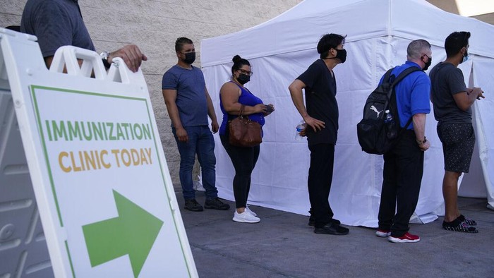 FILE- In this Wednesday, July 7, 2021, file photo, people wait in line for COVID-19 vaccinations at an event at La Bonita market, a Hispanic grocery store, in Las Vegas. The U.S. surgeon general said Sunday, July 18 that hes concerned about what lies ahead with cases of COVID-19 increasing in every state, millions still unvaccinated and a highly contagious virus variant spreading rapidly.. (AP Photo/John Locher, File)