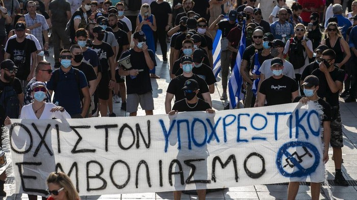 Virus Outbreak Greece Greek police use tear gas and water cannons to disperse anti-vaccine protesters during a rally at Syntagma square, central Athens, on Wednesday, July 21, 2021. Thousands of people protested against Greek government's measures to curb rising COVID-19 infections and drive up vaccinations in the country where almost 50% of Greeks and country residents have received at least one dose of the vaccine. (AP Photo/Yorgos Karahalis)