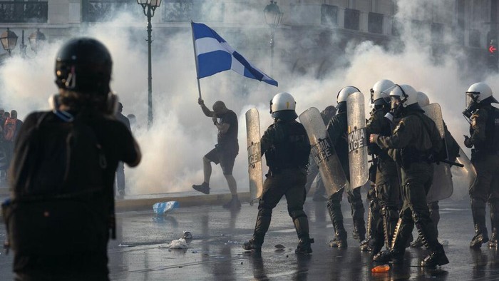 Greek police use tear gas and water cannons to disperse anti-vaccine protesters during a rally at Syntagma square, central Athens, on Wednesday, July 21, 2021. Thousands of people protested against Greek governments measures to curb rising COVID-19 infections and drive up vaccinations in the country where almost 50% of Greeks and country residents have received at least one dose of the vaccine. (AP Photo/Yorgos Karahalis)