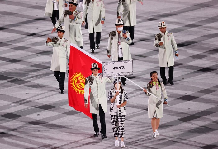 Tokyo 2020 Olympics - The Tokyo 2020 Olympics Opening Ceremony - Olympic Stadium, Tokyo, Japan - July 23, 2021. Flag bearers Kanykei Kubanychbekova of Kyrgyzstan and Denis Petrashov of Kyrgyzstan lead their contingent during the athletes parade at the opening ceremony REUTERS/Mike Blake
