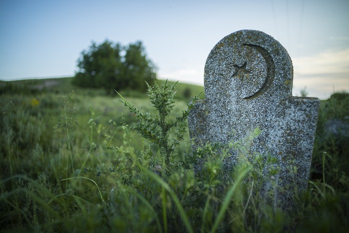Color image of a Muslim tomb stone in an abandoned cemetery.