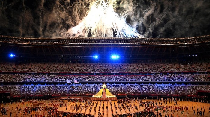 TOKYO, JAPAN - JULY 23: General view inside the stadium as fireworks go off while Naomi Osaka of Team Japan lights the Olympic cauldron with the Olympic torch during the Opening Ceremony of the Tokyo 2020 Olympic Games at Olympic Stadium on July 23, 2021 in Tokyo, Japan. (Photo by Dylan Martinez - Pool/Getty Images)