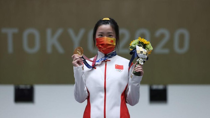 ASAKA, JAPAN - JULY 24: Gold Medalist Qian Yang of Team China poses on the podium during the medal ceremony for the 10m Air Rifle Womens event on day one of the Tokyo 2020 Olympic Games at Asaka Shooting Range on July 24, 2021 in Asaka, Saitama, Japan. (Photo by Kevin C. Cox/Getty Images)