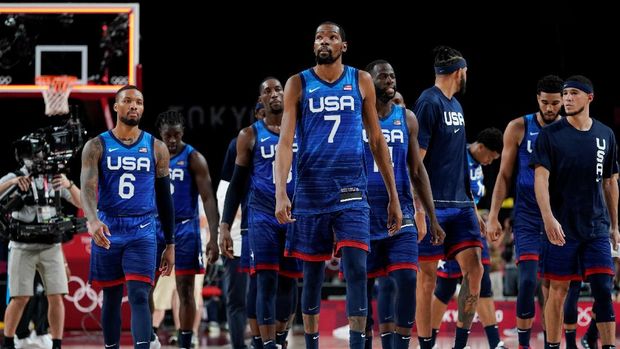 United States' Kevin Durant (7) walks off the court with teammates after a men's basketball preliminary round game against France at the 2020 Summer Olympics, Sunday, July 25, 2021, in Saitama, Japan. France won 83-76. (AP Photo/Charlie Neibergall)