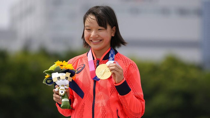 Gold medal winner Momiji Nishiya of Japan holds her medal after winning the womens street skateboarding finals at the 2020 Summer Olympics, Monday, July 26, 2021, in Tokyo, Japan. (AP Photo/Ben Curtis)