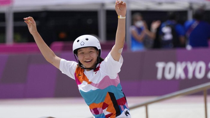 Gold medal winner Momiji Nishiya of Japan smiles after winning the womens street skateboarding finals at the 2020 Summer Olympics, Monday, July 26, 2021, in Tokyo, Japan. (AP Photo/Ben Curtis)