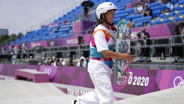 Gold medal winner Momiji Nishiya of Japan walks off the course after winning the women's street skateboarding finals at the 2020 Summer Olympics, Monday, July 26, 2021, in Tokyo, Japan. (AP Photo/Ben Curtis)