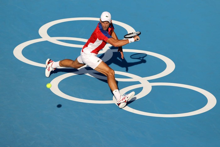 TOKYO, JAPAN - JULY 24: Novak Djokovic of Team Serbia plays a backhand during his Mens Singles First Round match against Hugo Dellien of Team Bolivia on day one of the Tokyo 2020 Olympic Games at Ariake Tennis Park on July 24, 2021 in Tokyo, Japan. (Photo by Clive Brunskill/Getty Images)