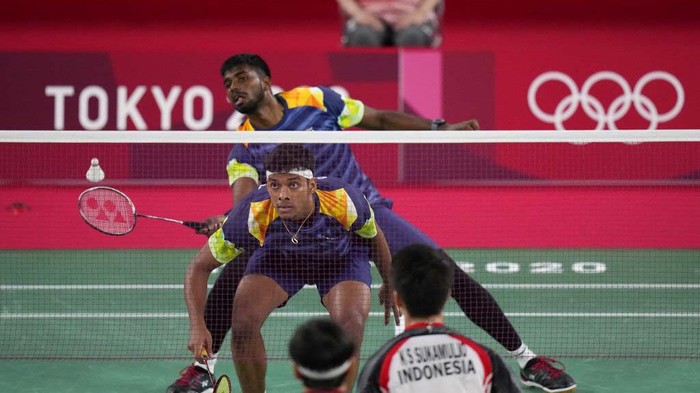 Indonesias Marcus Gideon and Kevin Sanjaya Sukamuljo celebrate a point against Indias Satwiksairaj Rankireddy and Chirag Shetty during their mens doubles group play stage badminton match at the 2020 Summer Olympics, Monday, July 26, 2021, in Tokyo, Japan. (AP Photo/Markus Schreiber)