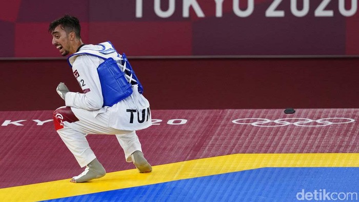 Tunisia's Mohamed Khalil Jendoubi celebrates after defeating South Kore's Jang Jun to winning a gold medal during the men's 58kg taekwondo match at the 2020 Summer Olympics, Saturday, July 24, 2021, in Tokyo, Japan. (AP Photo/Themba Hadebe)