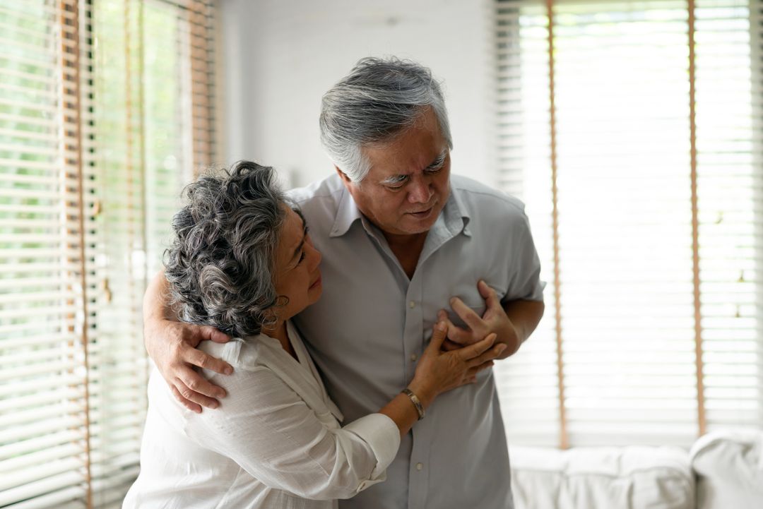 Senior Woman Suffering From Chest Pain While Sitting on Sofa at Home. Old Age, Health Problem, Vision and People Concept. Heart Attack Concept. Elderly Woman Suffering From Chest Pain Indoor