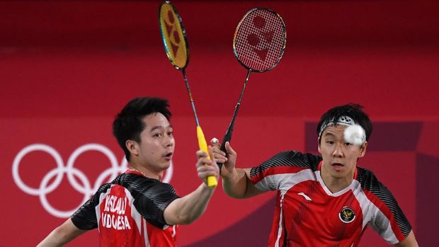 Ganda putra Indonesia Marcus Fernaldi Gideon/Kevin Sanjaya Sukamuljo mengembalikan kok ke arah ganda putra Taiwan Yang Lee/Chi-Lin Wang dalam penyisihan Grup A Olimpiade Tokyo 2020 di Musashino Forest Sport Plaza, Tokyo, Jepang, Selasa (27/7/2021). Marcus dan Kevin kalah 18-21, 21-15, 17-21 dari ganda putra Taiwan. ANTARA FOTO/Sigid Kurniawan/hp.