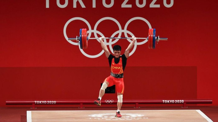 TOKYO, JAPAN - JULY 25: Fabin Li of Team China competes during the Weightlifting - Mens 61kg Group A on day two of the Tokyo 2020 Olympic Games at Tokyo International Forum on July 25, 2021 in Tokyo, Japan. (Photo by Chris Graythen/Getty Images)