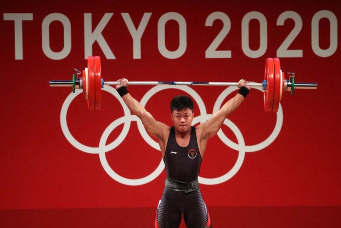 TOKYO, JAPAN - JULY 28: Rahmat Erwin Abdullah of Team Indonesia competes during the Weightlifting - Mens 73kg Group B  on day five of the Tokyo Olympic Games at Tokyo International Forum on July 28, 2021 in Tokyo, Japan. (Photo by Chris Graythen/Getty Images)