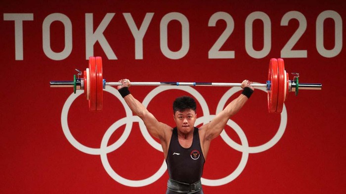 TOKYO, JAPAN - JULY 28: Rahmat Erwin Abdullah of Team Indonesia competes during the Weightlifting - Men's 73kg Group B  on day five of the Tokyo Olympic Games at Tokyo International Forum on July 28, 2021 in Tokyo, Japan. (Photo by Chris Graythen/Getty Images)
