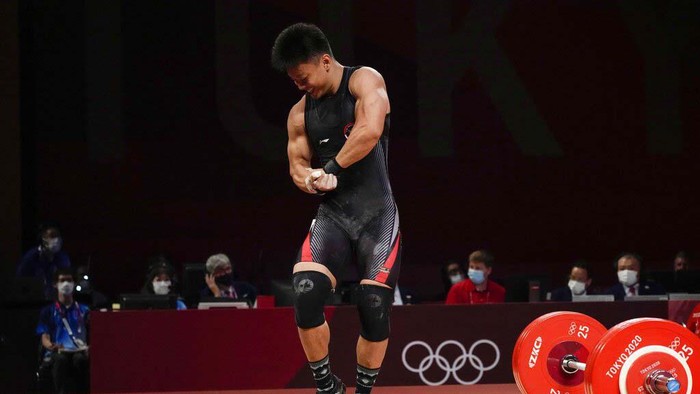 TOKYO, JAPAN - JULY 28: Rahmat Erwin Abdullah of Team Indonesia competes during the Weightlifting - Men's 73kg Group B  on day five of the Tokyo Olympic Games at Tokyo International Forum on July 28, 2021 in Tokyo, Japan. (Photo by Chris Graythen/Getty Images)