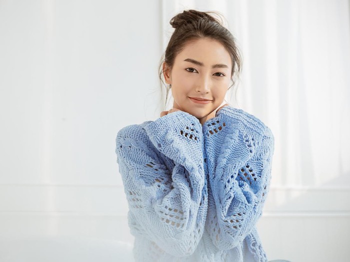 Portrait of young beautiful asian woman relax face in winter bedroom. Closeup sexy beauty fashion girl healthy makeup facial treatment perfect glow skin. Smile happy asia korean girl feel cold.