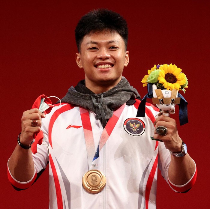 TOKYO, JAPAN - JULY 28:  Bronze medalist Rahmat Erwin Abdullah of Team Indonesia poses with the bronze medal during the medal ceremony for the Weightlifting - Mens 73kg Group A on day five of the Tokyo Olympic Games at Tokyo International Forum on July 28, 2021 in Tokyo, Japan. (Photo by Chris Graythen/Getty Images)