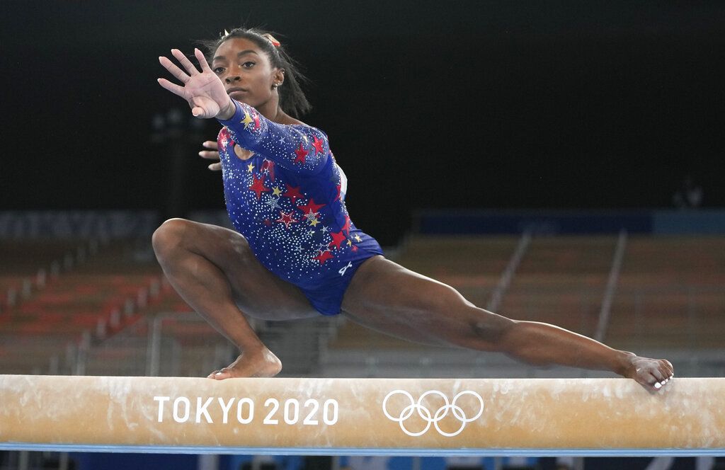 Simone Biles, of United States, performs on the vault during women's artistic gymnastic qualifications at the 2020 Summer Olympics, Sunday, July 25, 2021, in Tokyo. (AP Photo/Morry Gash)