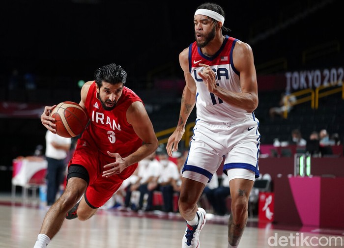Tokyo Olympics Basketball United States' Javale Mc Gee (11), center, is fouled by Iran's Pujan Jalalpoor (5), left, during men's basketball preliminary round game at the 2020 Summer Olympics, Wednesday, July 28, 2021, in Saitama, Japan. (AP Photo/Eric Gay)