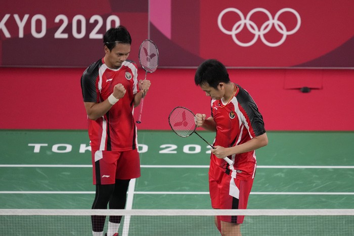 Indonesias Mohammad Ahsan and Hendra Setiawan celebrate after defeating Japans Takeshi Kamura and Keigo Sonoda during their mens doubles quarterfinal matchat the 2020 Summer Olympics, Thursday, July 29, 2021, in Tokyo, Japan. (AP Photo/Dita Alangkara)