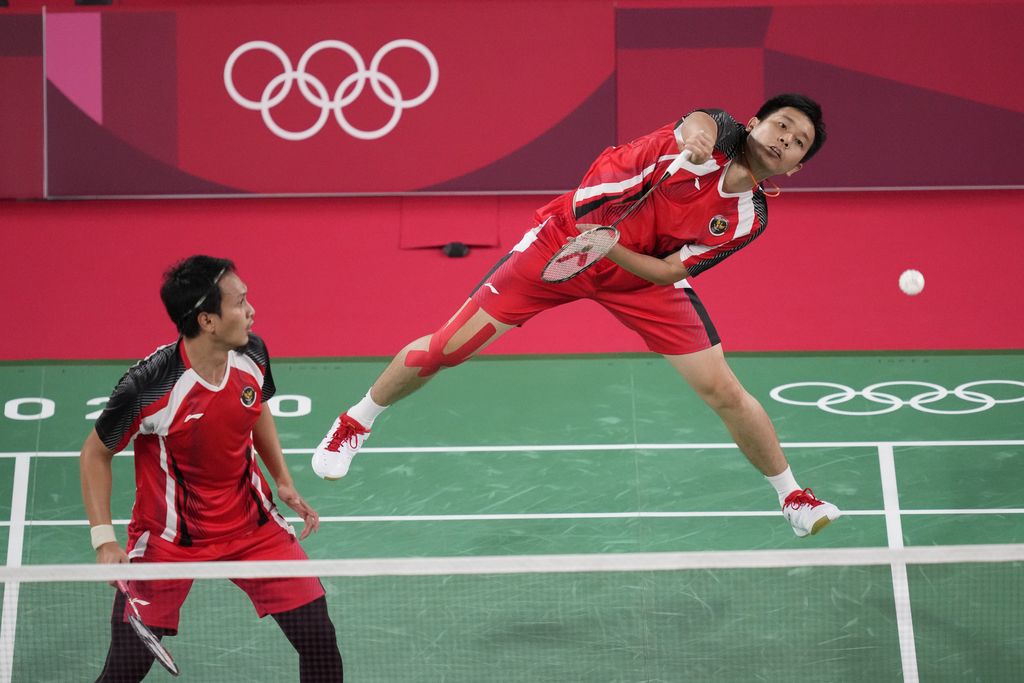 Indonesia's Mohammad Ahsan and Hendra Setiawan celebrate after defeating Japan's Takeshi Kamura and Keigo Sonoda during their men's doubles quarterfinal matchat the 2020 Summer Olympics, Thursday, July 29, 2021, in Tokyo, Japan. (AP Photo/Dita Alangkara)