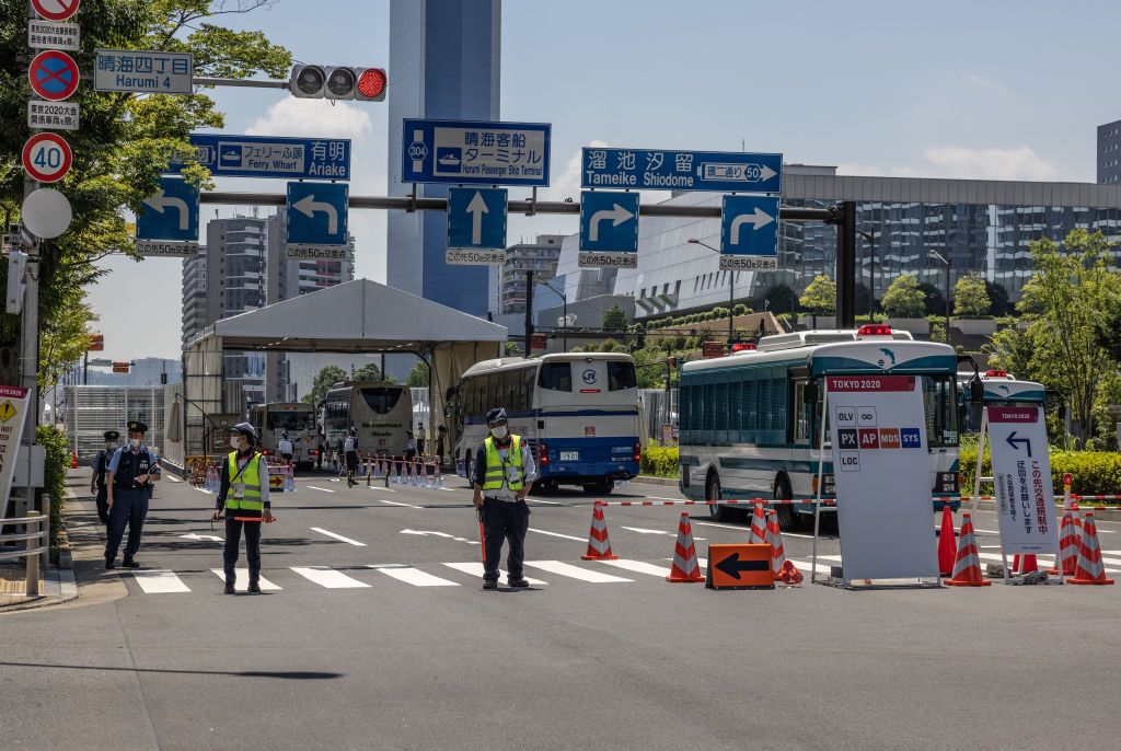 TOKYO, JAPAN - JULY 19: A police officer stands guard next to an accommodation building in the Tokyo Olympics athletes village on July 19, 2021 in Tokyo, Japan. Two South African football players have become the first athletes inside the Olympic Village to test positive for COVID-19. Other cases connected to the Games were also recently confirmed including eight Team GB members who have had to enter isolation after contact with a coronavirus case on their flight to Tokyo. (Photo by Carl Court/Getty Images)