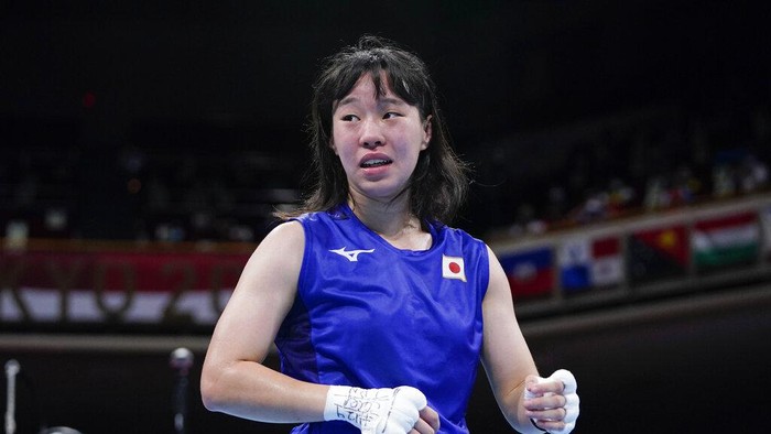 Japans Sena Irie reacts after winning her womens featherweight 57-kg boxing match against Romanias Maria Nechita at the 2020 Summer Olympics, Wednesday, July 28, 2021, in Tokyo, Japan. (AP Photo/Frank Franklin II, Pool)