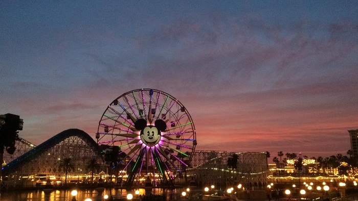 Anahiem, California, USA - December 21, 2014: Tourists wander around Disneys California Adventure at dusk. California Adventure is a park located adjacent to Disneyland, a major tourist attraction in Anaheim.