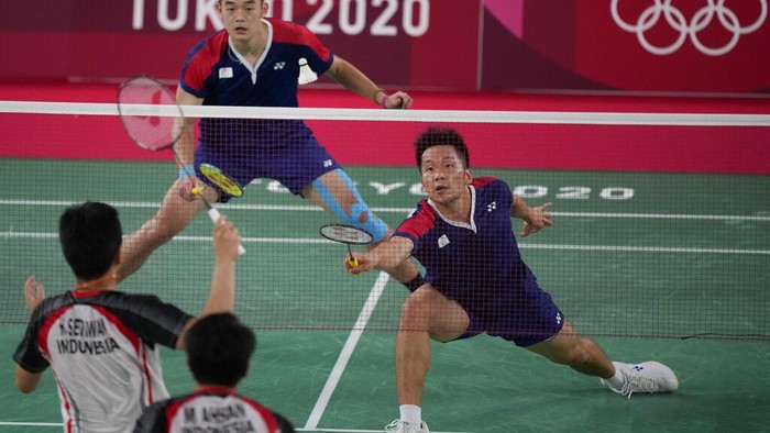 Taiwans Lee Yang and Wang Chi-Lin play against Indonesias Mohammad Ahsan and Hendra Setiawan during their mens doubles badminton semifinal match at the 2020 Summer Olympics, Friday, July 30, 2021, in Tokyo, Japan. (AP Photo/Dita Alangkara)