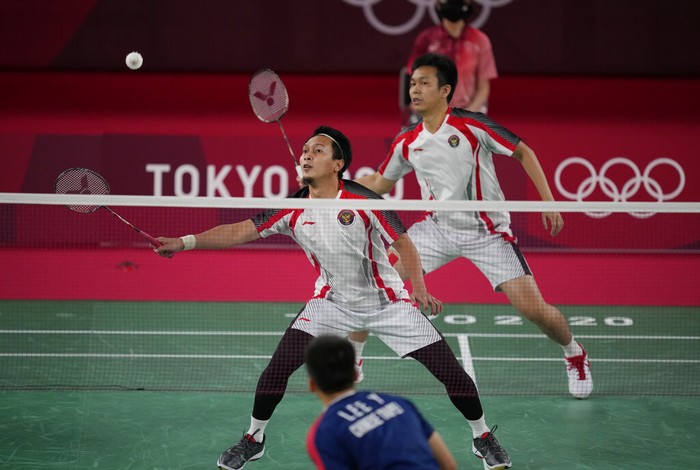 Indonesias Mohammad Ahsan and Hendra Setiawan compete against Taiwans Lee Yang and Wang Chi-Lin during their mens doubles badminton semifinal match at the 2020 Summer Olympics, Friday, July 30, 2021, in Tokyo, Japan. (AP Photo/Dita Alangkara)